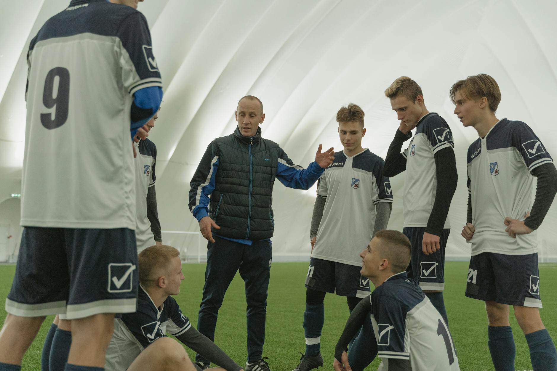 a football coach talking to his team to help them develop their skills