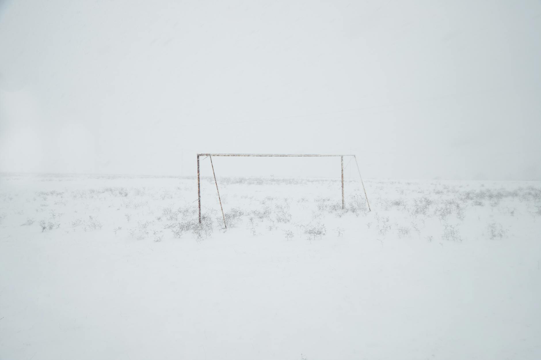 A frozen football pitch which is definitely unplayable.